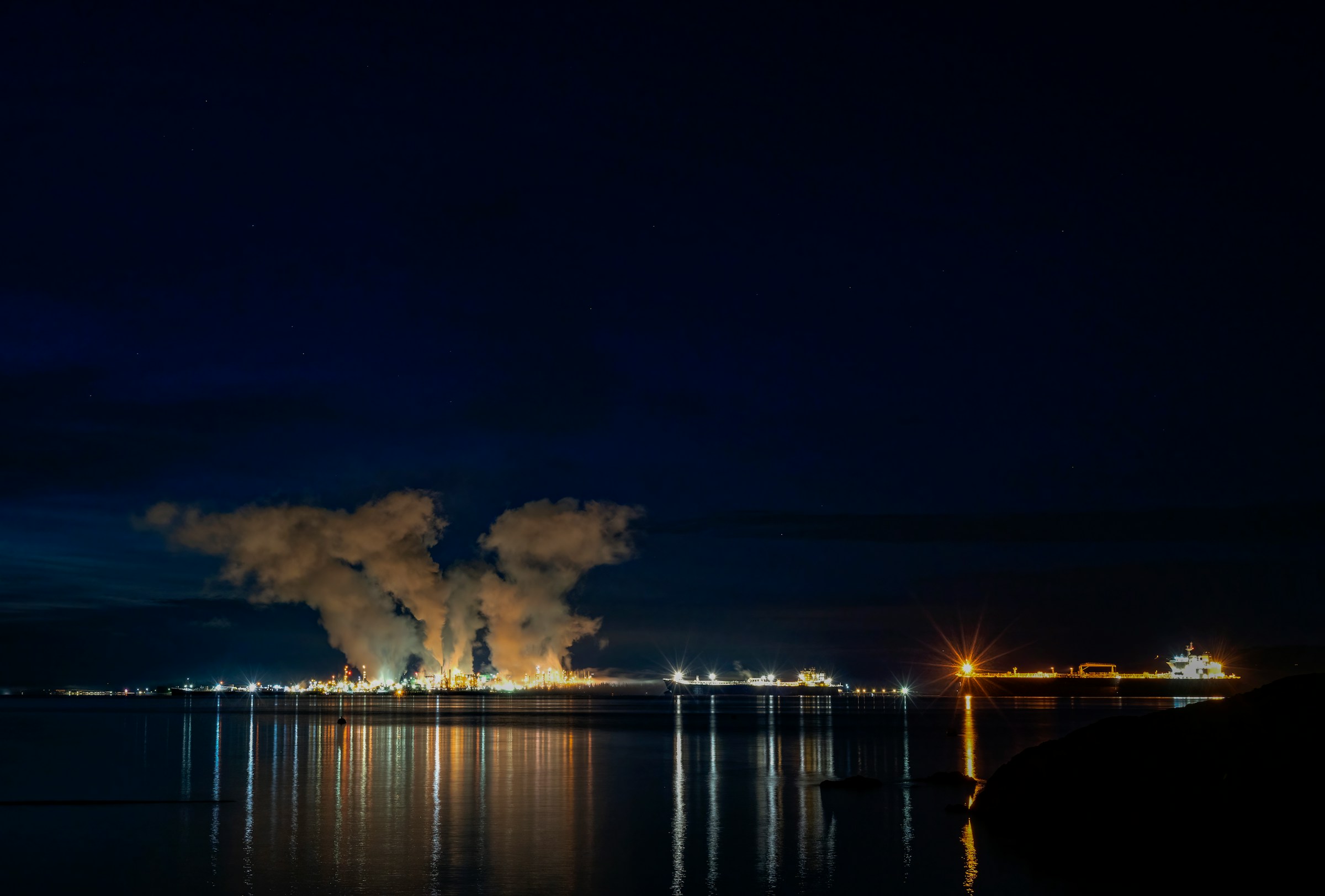 Refinery across the harbor at night